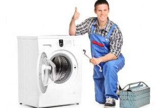 Repairman giving thumb up next to a washing machine